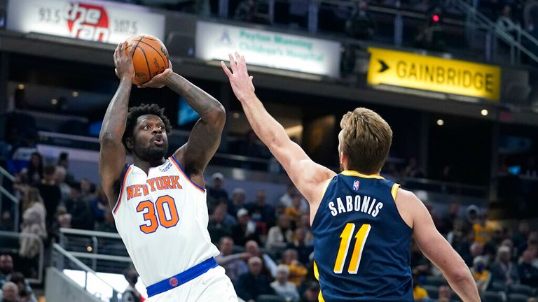 &#39; Julius Randle (30) shoots over Indiana Pacers&#39; Domantas Sabonis (11) during the first half of an NBA basketball game Wednesday, Dec. 8, 2021, in Indianapolis. (AP Photo/Darron Cummings)