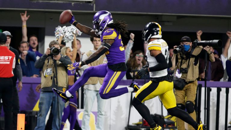 Minnesota Vikings running back Dalvin Cook (33) scores on a 29-yard touchdown run ahead of Pittsburgh Steelers free safety Minkah Fitzpatrick, right, during the first half of an NFL football game, Thursday, Dec. 9, 2021, in Minneapolis. (AP Photo/Andy Clayton-King)


