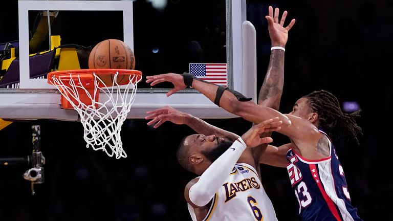 Brooklyn Nets forward Nic Claxton dunks over Los Angeles Lakers forward LeBron James
