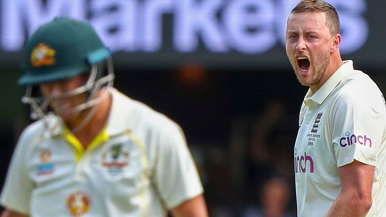 England's Ollie Robinson reacts after dismissing Australia's David Warner during day two of the first Ashes cricket test