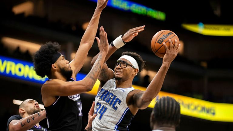 Orlando Magic center Wendell Carter Jr. (34) is defended by forward Marvin Bagley III (35) during the second half of an NBA basketball game in Sacramento, Calif., Wednesday, Dec. 8, 2021. (AP Photo/Jose Luis villegas)