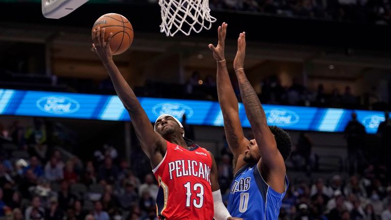 New Orleans Pelicans guard Kira Lewis Jr. (13) shoots as Dallas Mavericks forward Sterling Brown (0) defends during the first half of an NBA basketball game in Dallas, Friday, Dec. 3, 2021. (AP Photo/Tony Gutierrez)


