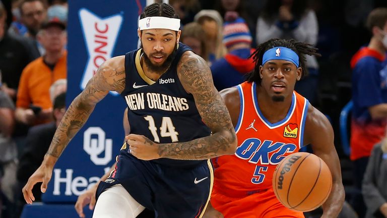 New Orleans Pelicans forward Brandon Ingram and Oklahoma City Thunder forward Luguentz Dort fight for the ball