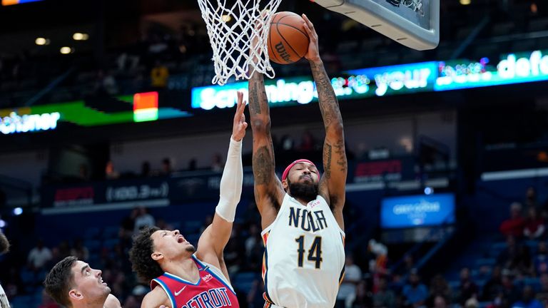 New Orleans Pelicans forward Brandon Ingram pulls down a rebound over Detroit Pistons guard Cade Cunningham