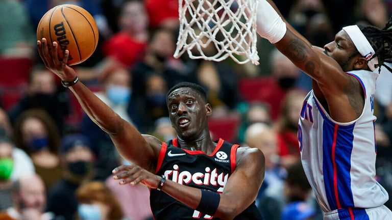 Portland Trail Blazers forward Tony Snell, left, shoots next to Detroit Pistons forward Jerami Grant during the second half of an NBA basketball game in Portland, Ore., Tuesday, Nov. 30, 2021. (AP Photo/Craig Mitchelldyer)