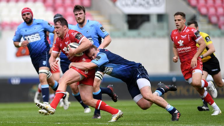 LLANELLI, WALES - MAY 15: Ryan Elias of Scarlets is tackled by Kristian Dacey of Cardiff Blues during the Guinness Rainbow Cup match between the Scarlets and Cardiff Blues at Parc y Scarlets on May 15, 2021 in Llanelli, Wales. (Photo by Athena Pictures/Getty Images)