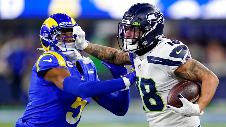 Seattle Seahawks wide receiver Freddie Swain, right, is pushed out of bound after a catch by Los Angeles Rams cornerback Jalen Ramsey (5) during the second half of an NFL football game Tuesday, Dec. 21, 2021, in Inglewood, Calif. (AP Photo/Ashley Landis