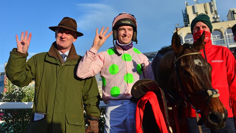 Sharjah and Patrick Mullins with trainer & Dad Willie celebrate after winning the race for the 4th time with groom David Porter.