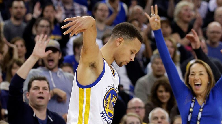 The crowd reacts after Golden State Warriors&#39; Stephen Curry made a 3-point basket during the first half of an NBA basketball game against the Boston Celtics