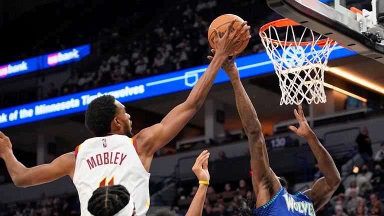Cleveland Cavaliers forward Evan Mobley blocks a shot by Minnesota Timberwolves forward Taurean Prince