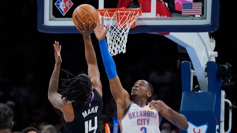 Oklahoma City Thunder guard Shai Gilgeous-Alexander (2) defends as Los Angeles Clippers guard Terance Mann (14) shoots in the first half of an NBA basketball game, Saturday, Dec. 18, 2021, in Oklahoma City. (AP Photo/Sue Ogrocki)


