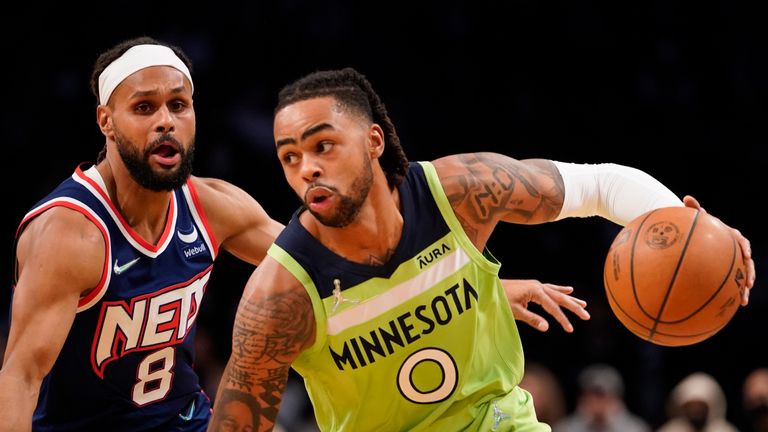 Minnesota Timberwolves guard D&#39;Angelo Russell (0) drives against Brooklyn Nets guard Patty Mills (8) during the first half of an NBA basketball game Friday, Dec. 3, 2021, in New York. (AP Photo/Mary Altaffer)


