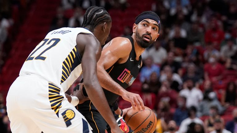 Miami Heat guard Gabe Vincent, right, looks for an open teammate past Indiana Pacers guard Caris LeVert (22) during the second half of an NBA basketball game, Tuesday, Dec. 21, 2021, in Miami. (AP Photo/Wilfredo Lee)


