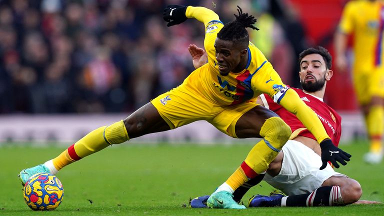Wilfried Zaha battles for possession with Bruno Fernandes durng Manchester United vs Crystal Palace