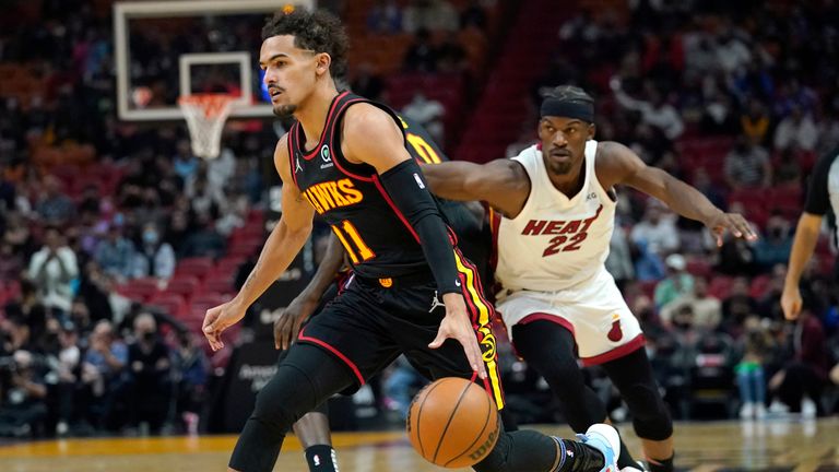 Atlanta Hawks Trae Young ranger heads for the basket as Miami Heat striker Jimmy Butler defends during the first half of an NBA basketball game on Friday, January 14, 2022 in Miami.