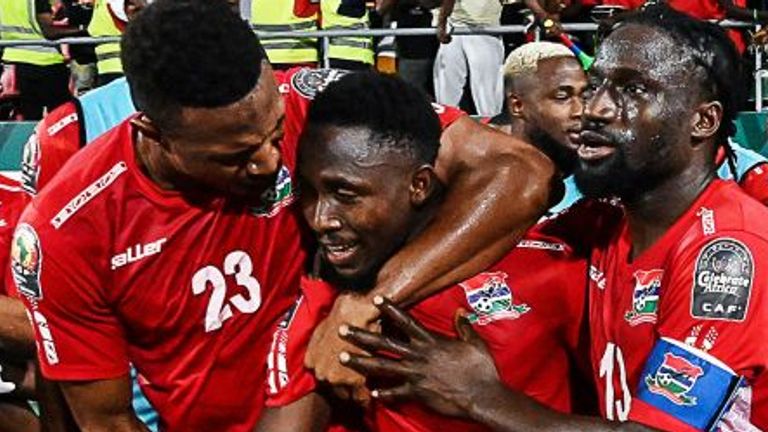 Gambia's midfielder Ablie Jallow (C) celebrates with teammates after scoring a goal during the Group F Africa Cup of Nations (CAN) 2021 football match between Gambia and Tunisia at Limbe Omnisport Stadium in Limbe on January 20, 2022.