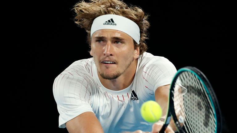 Alexander Zverev of Germany plays a backhand return to compatriot Daniel Altmaier  during their first round match at the Australian Open tennis championships in Melbourne, Australia, Monday, Jan. 17, 2022. (AP Photo/Hamish Blair)