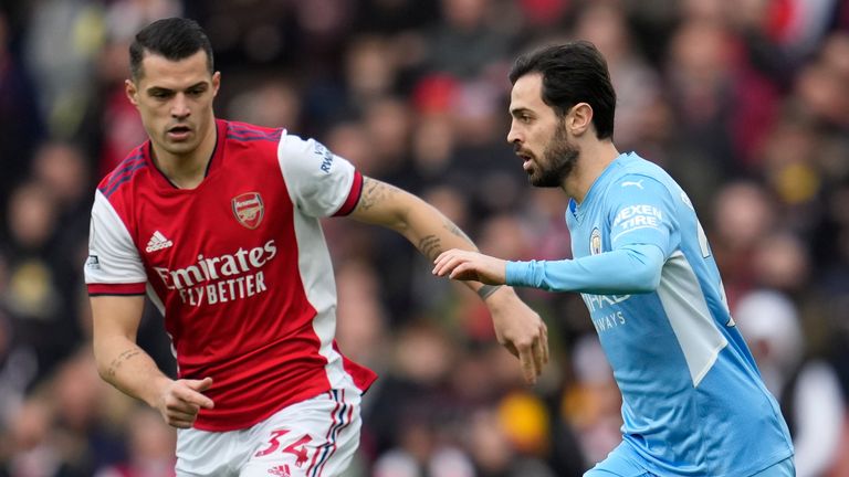 Arsenal's Granit Xhaka challenges Manchester City's Bernardo Silva