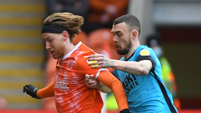 BLACKPOOL, ENGLAND - JANUARY 22: Blackpool's Josh Bowler battles with Millwall's Scott Malone during the Sky Bet Championship match between Blackpool and Millwall at Bloomfield Road on January 22, 2022 in Blackpool, England. (Photo by Dave Howarth - CameraSport via Getty Images)                                                                                                                           