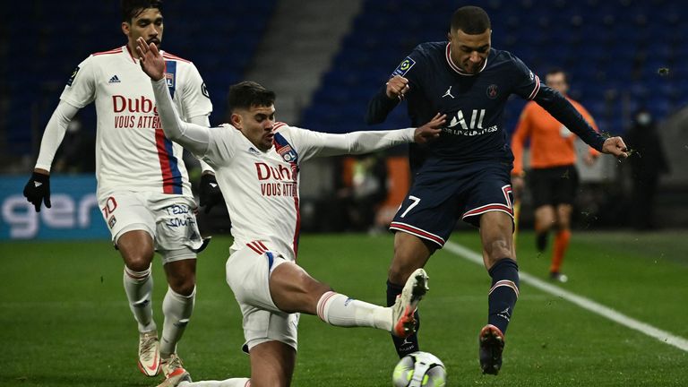 Bruno Guimaraes in action for Lyon against PSG's Kylian Mbappe