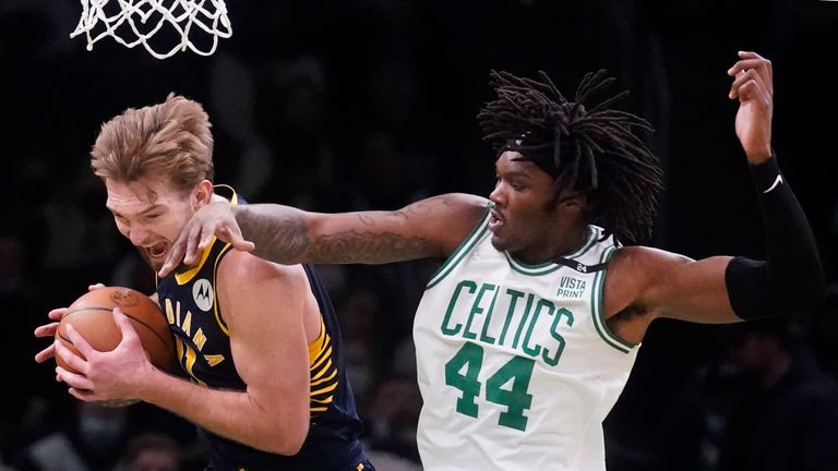 Indiana Pacers forward Domantas Sabonis, left, grabs a rebound against Boston Celtics center Robert Williams III (44) during the second half of an NBA basketball game, Monday, Jan. 10, 2022, in Boston. (AP Photo/Charles Krupa)