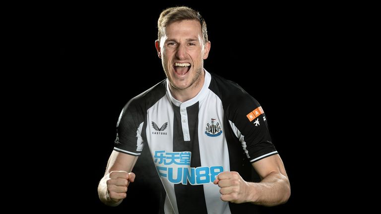 Chris Wood poses for photos after signing for Newcastle United