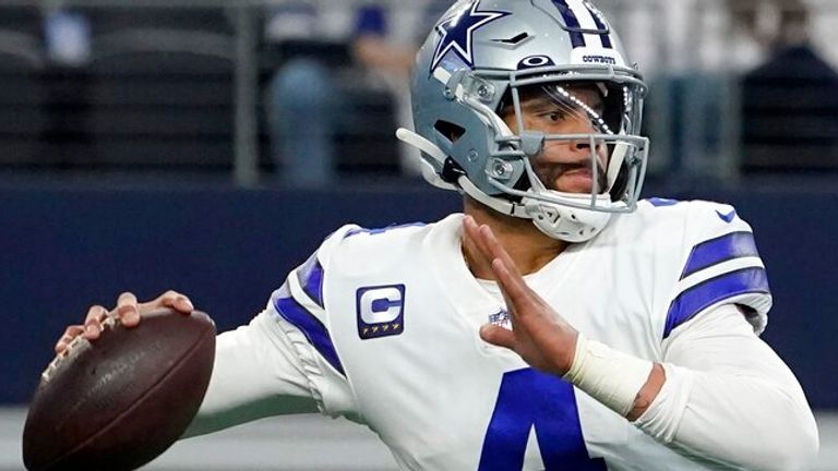 Dallas Cowboys quarterback Dak Prescott (4) looks before throwing a pass in the first half of an NFL wild-card playoff football game against the San Franciso 49ers in Arlington, Texas, Sunday, Jan. 16, 2022. (AP Photo/Tony Gutierrez)