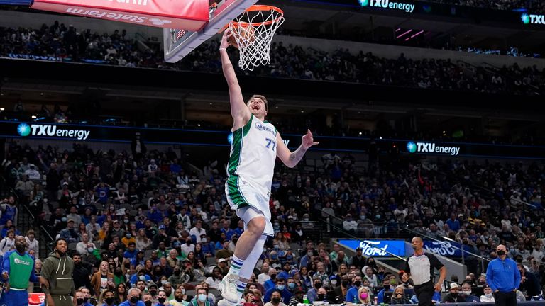 Dallas Mavericks guard Luka Doncic leaps to the basket on a breakaway play