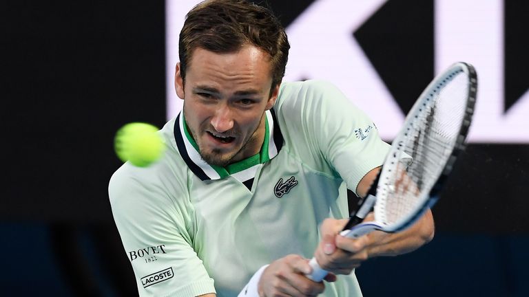 Daniil Medvedev of Russia plays a backhand return to Felix Auger-Aliassime of Canada during their quarterfinal match at the Australian Open tennis championships in Melbourne, Australia, Wednesday, Jan. 26, 2022. (AP Photo/Andy Brownbill)
