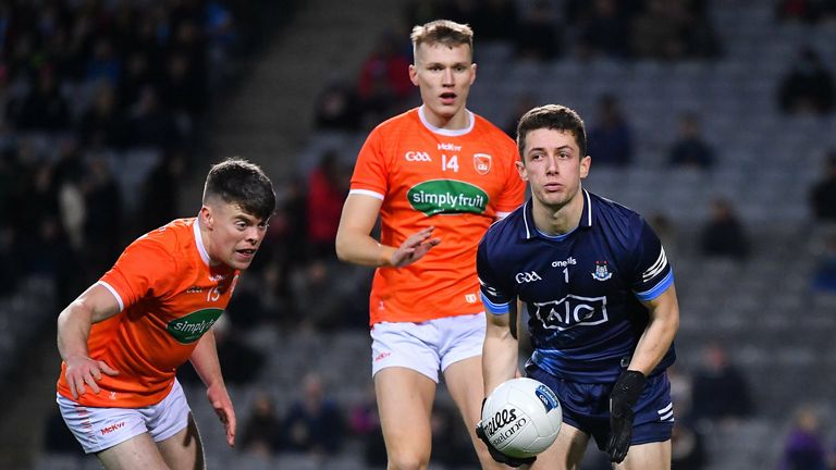 Dublin goalkeeper Evan Comerford prepares to clear under pressure from Armagh players Jason Duffy , left, and Rian O'Neill