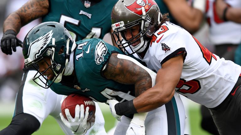 Philadelphia Eagles running back Kenneth Gainwell (14) is stopped by Tampa Bay Buccaneers cornerback Ross Cockrell (43) during the first half of an NFL wild-card football game Sunday, Jan. 16, 2022, in Tampa, Fla. 