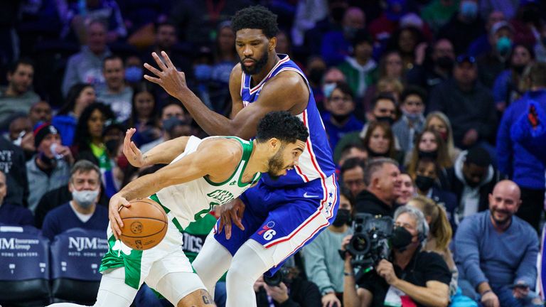 Boston Celtics&#39; Jayson Tatum, drives to the basket against Philadelphia 76ers&#39; Joel Embiid, right, during the first half of an NBA basketball game, Friday, Jan. 14, 2022, in Philadelphia.