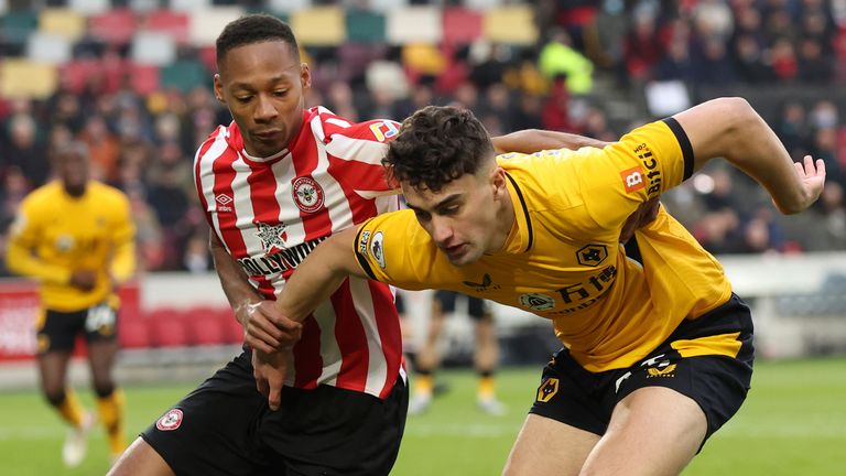 Brentford's Ethan Pinnock challenges Wolves' Max Kilman (AP)