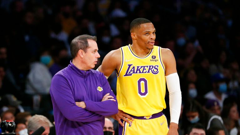 Los Angeles Lakers head coach Frank Vogel confers with guard Russell Westbrook (0) during the first half of an NBA basketball game against the Sacramento Kings in Los Angeles, Friday, Nov. 26, 2021. (AP Photo/Ringo H.W. Chiu)