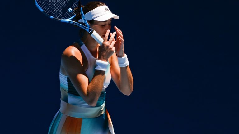 Garbine Muguruza of Spain reacts during her second round match against Alize Cornet of France at the Australian Open tennis championships in Melbourne, Australia, Thursday, Jan. 20, 2022. (AP Photo/Hamish Blair)