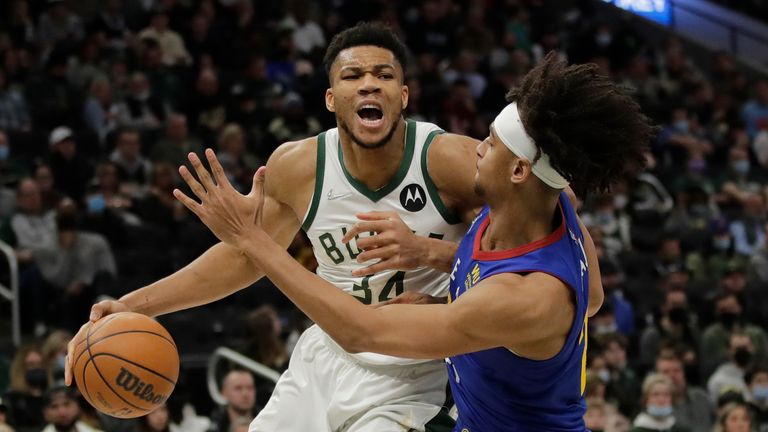 Milwaukee Bucks&#39; Giannis Antetokounmpo drives to the basket against Denver Nuggets&#39; Zeke Nnaji during the second half of an NBA basketball game Sunday, Jan. 30, 2022, in Milwaukee. 