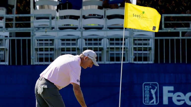 Jim Furyk reaches for his ball after hitting a hole-in-one on the 17th hole during the first round of the Sony Open golf tournament, Thursday, Jan. 13, 2022, at Waialae Country Club in Honolulu. (AP Photo/Matt York)


