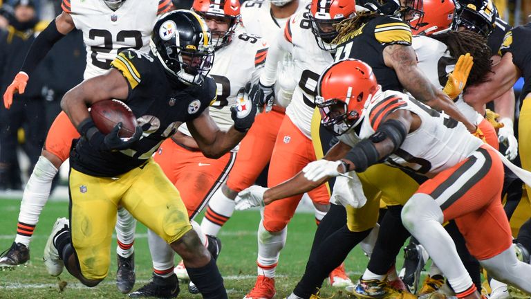 Pittsburgh Steelers running back Najee Harris (22) breaks past Cleveland Browns defensive end Jadeveon Clowney (90) on his way to a touchdown during the second half an NFL football game, Monday, Jan. 3, 2022, in Pittsburgh. The Steelers won 26-14.