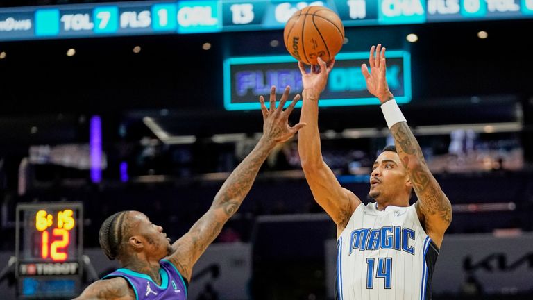 Orlando Magic Ranger Gary Harris shoots over Charlotte Hornets guard Terry Rozier during an NBA basketball game on Friday, January 14, 2022 in Charlotte, NC 