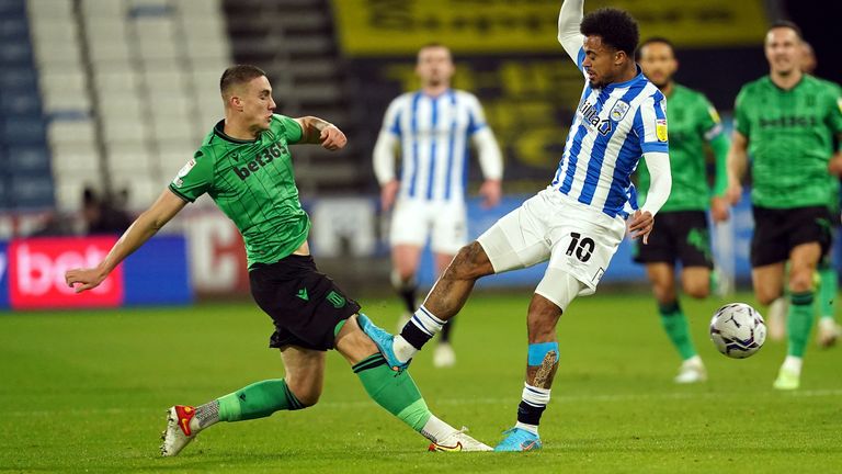Huddersfield Town's Josh Koroma catches Stoke City's Taylor Harwood-Bellis on the knee
