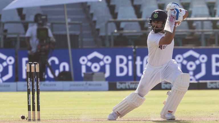 Indian captain Virat Kohli and South African fielder Marco Jansen watch as the ball flies toward the boundary during the second day of the third and final test match between South Africa and India in Cape Town