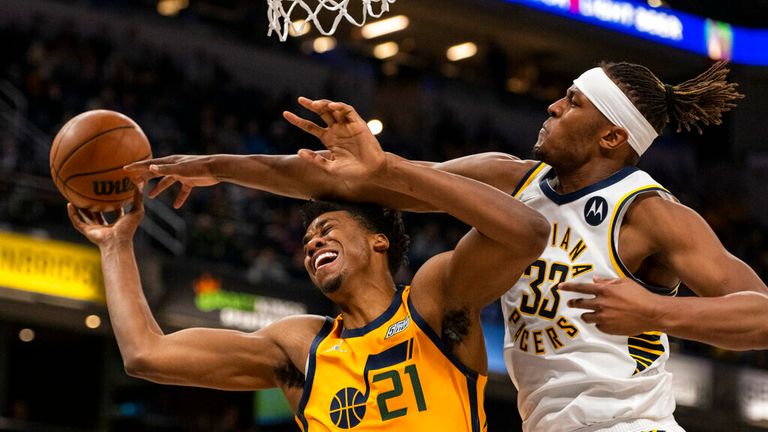 Indiana Pacers center Myles Turner (33) fouls center Hassan Whiteside (21) who was attempting to score during the second half of an NBA basketball game in Indianapolis on Saturday, January 8, 2022. (AP Photo / Doug McSchooler)