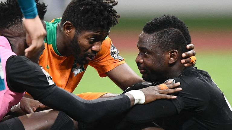Ivory Coast's goalkeeper Badra Ali Sangare (R) and Ivory Coast's midfielder Ibrahim Sangare (C) react after losing the Africa Cup of Nations (CAN) 2021 round of 16 football match between Ivory Coast and Egypt at Stade de Japoma in Douala on January 26, 2022. (Photo by CHARLY TRIBALLEAU / AFP) (Photo by CHARLY TRIBALLEAU/AFP via Getty Images)
