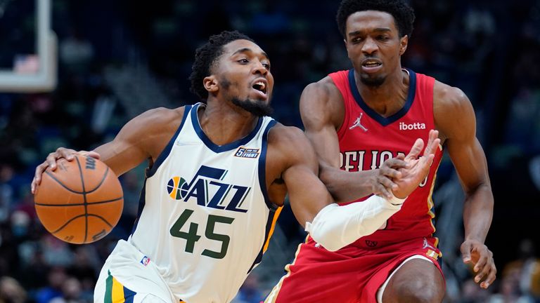 Utah Jazz guard Donovan Mitchell (45) drives to the basket against New Orleans Pelicans forward Herbert Jones in the second half of an NBA basketball game in New Orleans, Monday, Jan. 3, 2022. The Jazz won 115-104. 