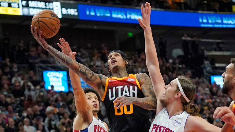 Utah Jazz guard Jordan Clarkson goes to the basket as Detroit Pistons&#39; Cade Cunningham and Kelly Olynyk defend