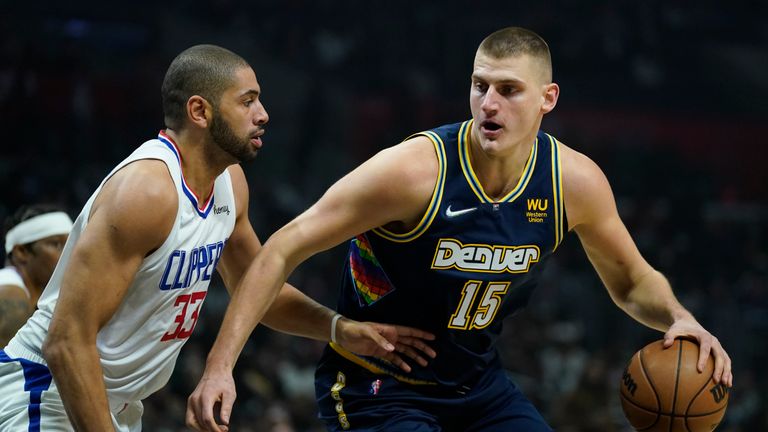 Los Angeles Clippers forward Nicolas Batum (33) defends against Denver Nuggets center Nikola Jokic (15) during the first half of an NBA basketball game in Los Angeles, Sunday, Dec. 26, 2021. (AP Photo/Ashley Landis)