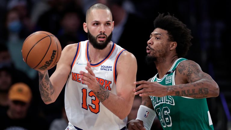 New York Knicks guard Evan Fournier (13) passes the ball as Boston Celtics guard Marcus Smart defends during the second half of an NBA basketball game Thursday, Jan. 6, 2022, in New York. The Knicks won 108-105. 