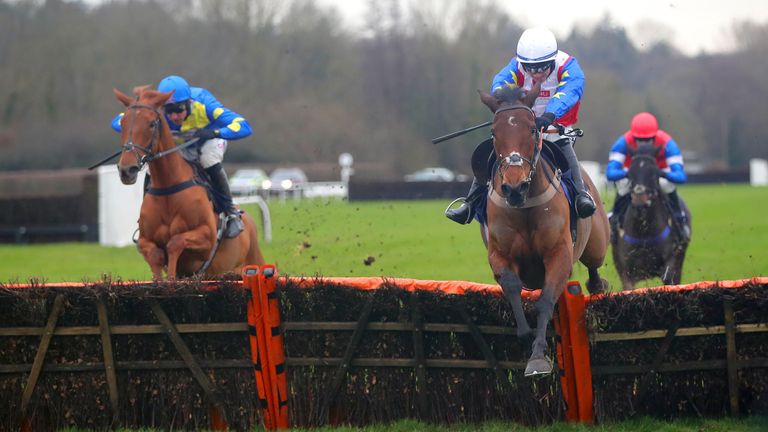 Love Envoi ridden by jockey Jonathan Burke (white cap) clears a hurdle on their way to winning the Winter Million Mares&#39; Novices&#39; Hurdle during day one of The Winter Million Festival at Lingfield Park