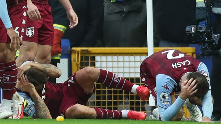 Lucas Digne and Matty Cash are hit by an bottle thrown from the crowd