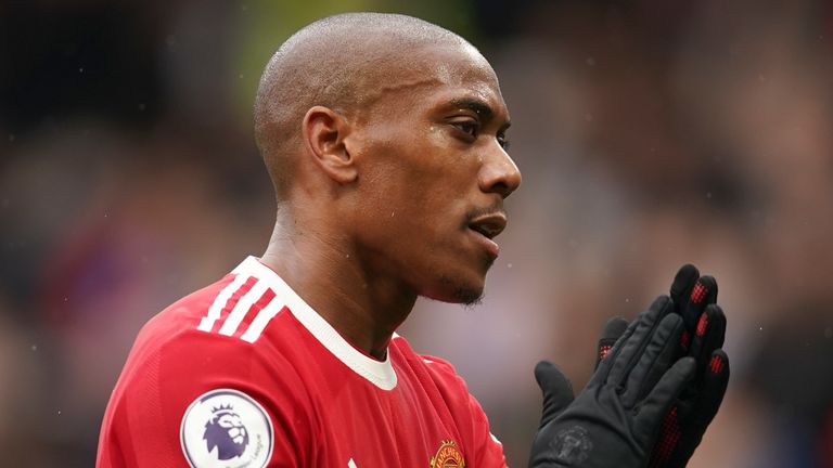 Anthony Martial pays tribute to a fan as he walks off the field at halftime, during the Premier League soccer match between Manchester United and Everton, in Old Trafford, Manchester, England, Saturday, October 2, 2023. (Dave Thompson, pool via AP)